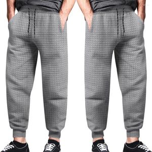 Pantaloni maschili adatti a colore solido texture waffle cohingstring pantaloni con tasche in vita elastica per la primavera autunno casual morbido