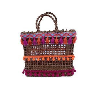 Totes New hollow grass woven bag ethnic style mesh simple and casual womens bag wool ball colorful tassel bagH24219