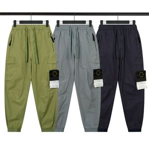 23Designer New Autumn Stone Zipper Pocket Elastic Pantsハイエンドストーンツールカジュアルシンパンツ。