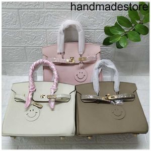 2024 Designer Bag Togo Top Layer Cow Leather Liten Litchi Mönster Portable One-Shulder Läder Buckle Bride Bride