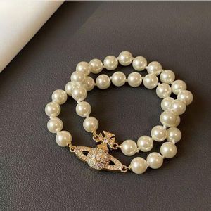 Trevlig kvinnlig manschettarmband Hot Brand Pearl Chain Planet Armband Saturn Pearl Armband Punk Women Fashion Designer Smycken Magnetiska Buckle Pearl Armband