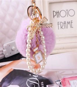2020 Fashion Pearl Chain Crystal Bottle Bow Pompom Keychain Car Women Handbag Key Chain Ring Y Puff Ball Keychains Jewelry5211983