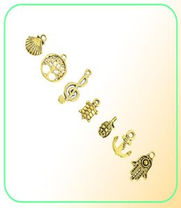 Designs mistos retro cor dourada chave leme concha tartaruga pássaro mão torre bicicleta borboleta coruja encantos para diy jóias montagem 50pc6996005
