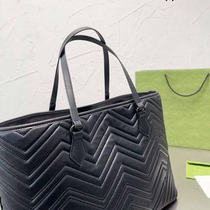 Large volume tote bag shopping bag vshaped design genuine leather handbag brass accessories with ceramic effect facing cotton linen lining bag designerbags