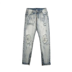 Överskridande europeiska och amerikanska punkterade motorcykelkulslösa jeans, herrgata smal passande liten fot retro denim långa byxor