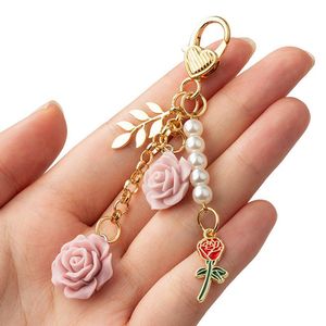 Keychains Lanyards 8Colors 3D Rose Camellia Keychain Women Girls Sweet Pearl Tassel Flower Keyring With Metal Leaf For Earphone Case Bag Decoration 230831