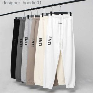 Mens Tracksuits Herrbyxor Kvinnor Casual Pants Long Elastic Band Solid Color Black and White Grey Letters Pressed Adhesive Fashionable Casual Clothing Size M L XL XXL