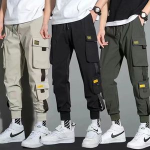 Calças masculinas finas streetwear calças casuais homens fitas harem calças de jogging masculino fino ajuste primavera calças de carga multi-bolsos calças femininas jx1 230927