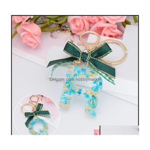 Schl￼sselringe Schmuck Mode 26 Buchstaben Harz Schl￼sselketten f￼r Frauen Gold Folie Weihnachten Bowknot Bag Anh￤nger Zauber Handtasche Aessories TASS DHXGS