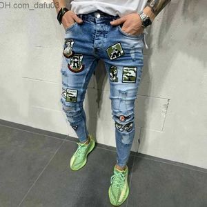 Mäns jeans män jeans kenntrice s tryckt lapptäcke trendig design rippade nödställda broderier denim långa män byxor plus storlek z230801