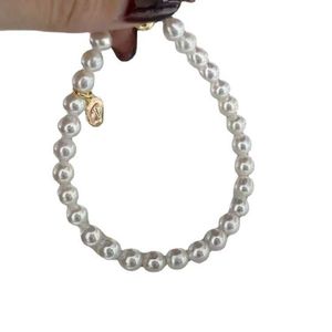 TFF di marca originale stesso braccialetto di perle d'acqua dolce avvolto in oro 14K con fibbia ad aspirazione d'amore da 5,5-6 mm vicino a una forte lampadina a cerchio perfetto
