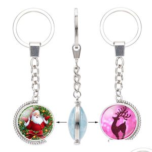 Keychains Lanyards julglas cabochon dubbla sidor rena träd Santa Claus Bell Snowman Pendant Rotable Key Chain Jewelry Dr Dhhge