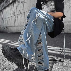 Pantaloni maschili in stile atmosfera maschile jeans side corda pantaloni intrecciati alla moda di alta strada lacrima hip-hop denim sciolto e casual z230815