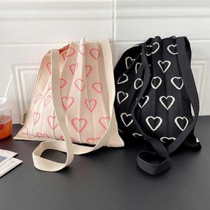 Axelväskor koreansk version nischdesign rosa kärlek stickad veckväska med stor kapacitetsstudent mångsidig hopfällbar shopping för kvinnor