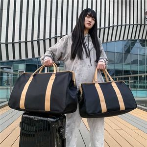 Bolsa de viagem de curta distância moda feminina bolsa de bagagem masculina grande capacidade à prova dwaterproof água trole caso saco de viagem