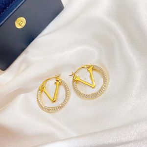 18k gold plated logo rhinestone hoop earrings. Brand fashion designer earrings for women. luxurious earrings in a classic style. aretes designer jewelry with stamps