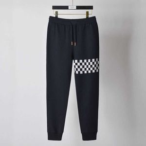 Ursprungligen designad högkvalitativ asymmetrisk schackbräde ruttbyxor för män och kvinnor Casual Sports Pants Fashion