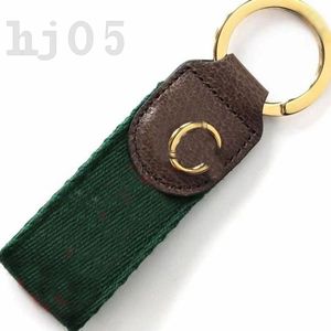 Populär nyckelringsbrun läder Keyring Red och Green Webbing Bag Charms Fashion Accessories Gold Plated Parts Designer Keychain Grace Unisex PJ055 C23