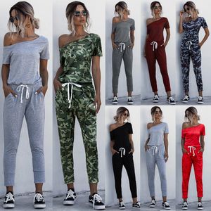 Kvinnors jumpsuits rompers mode kvinnor sommar fast färg jumpsuits dragskon designfickor dekor sned krage kort ärm mitt midja smala jumpsuits 230325