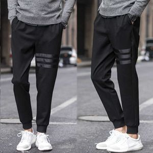 メンズパンツ2022新しいソリッドカジュアルメンズジョガーパンツ女性Khakiバギーズボン縞模様の男の子スリム男性男性用衣料品Streetwear M-5XL W0325