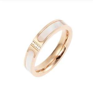 Manufacturers direct supply Korean version of shell inlaid Hao stone three diamond ring mother shell 18K rose gold titanium steel color ring female