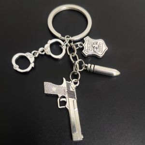 Pistol Handbojor Bullet Police Dept Military Entusiast Silver Color Car Key Chains Ring Smycken Tillbehör Fashion Pendant