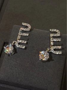 Popular Miu letter studded earrings with diamond design, fashionable and versatile commuting style, asymmetrical earrings