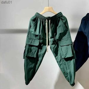 Мужские брюки Мужская одежда Лето Новое 2023 Комбинезон Quick Dry Dry Outdoor Bacgy Casual Pants Корейские сгруппированные ноги девять очков.
