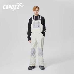 Copozz Men女性スキーパンツ風車防水ビブオーバーオールズボン冬の温かい屋外スポーツスノーボードスキー服231221