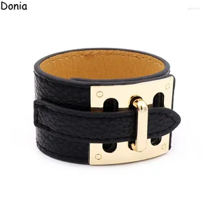 Bangle Donia Jóia Europeia e Americana Moda 316L Botões de aço inoxidável Crela de couro larga Pulseira de ponta sofisticada.