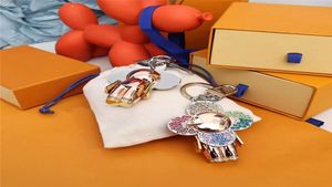 Designer Keychain Luxury Fashion Stylish Sun Flower Doll Pendant Keychains Three Colors Keys Buckle Mens Womens Keys Ornaments 2201281666