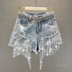 Kjolar tunga pärlstav paljett fransade rippade denim shorts kvinnor 2023 sommar bär ny hög midja bantning breda ben heta byxor tassel shorts