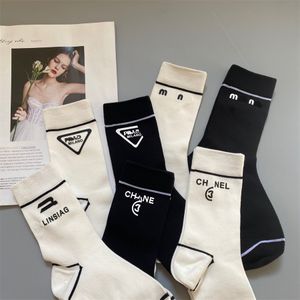 Women's socks hand-pressed leather label fashion letter stripe design socks in black and white basic pair socks