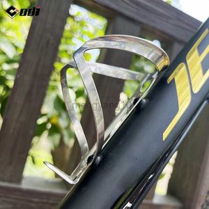 Gaiolas para garrafas de água ODI Suporte para garrafa de bicicleta 27g Suporte para garrafa de ciclismo em liga de titânio leve MTB Suporte para garrafa de água para ciclismo de estrada HKD230719