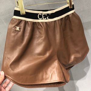 Shorts de couro PU com cintura elástica com estampa de logotipo feminino SML