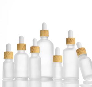 Bottiglie di profumo di oli essenziali di vetro smerigliato all'ingrosso con contenitori per liquidi per aromaterapia con tappo a grana di legno