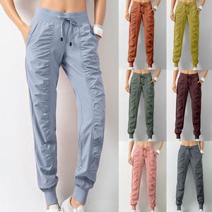 Kvinnors byxor capris sweatpants tyg dragkörning löpande sport joggar kvinnor snabb torr atletisk gym fitness med två sidofickor träning byxor 230413