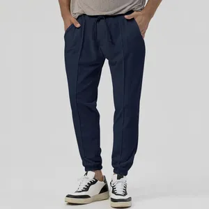 Calça masculina 2023 cordão cintura cor pura moda versátil casual com pernas afuniladas grande quantidade e ótimo preço.