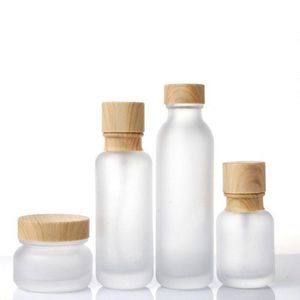 Frosted Glass Jar Cream Flaskor Runt kosmetiska burkar Hand Face Lotion Pump Bottle With Wood Cap Emjvc