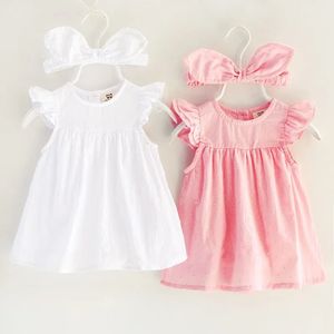 Платья для девочек Цельное платье для маленьких девочек Летние весенние хлопковые платья для малышей Одежда для первого года Одежда для новорожденных Юбка с лентой для волос 231124