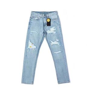 Jeans de moda com buracos azuis Sorrindo calças de padrões de rosto moderno jeans de grife esportivo e versátil calça casual slim