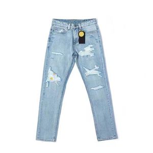 Modische Herren Jeans mit blauen Löchern lächelndes Gesicht Muster Hose trendige Herren Designer Jeans sportliche und vielseitige lässige schmale Hose