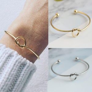 Bracciale rigido con nodo di temperamento semplice alla moda per braccialetti con polsini legati in acciaio inossidabile da donna Gioielli eleganti per feste da donna