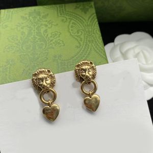 Lion head heart charm earrings. Antiqued gold-plated bronze. Luxury designer earrings for women. Wedding party bridal gifts aretes designer jewelry