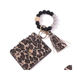 Nyckelringar Sil P￤rlor Ringstr￤ngar Armband Armband Nyckelring med Cheetah Leopard L￤der Tassel ID -kortpl￥nbok Purse M￤n kvinnor Handm Dhjxw