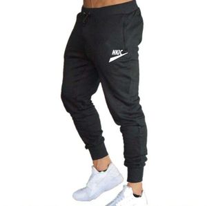 2023 Marca Calças Skinny Casuais Masculinas Joggers Fitness Treino Masculino Marca Calças de Faixa Novo Outono Masculino Moda Marca LOGOTIPO Imprimir