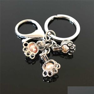 Keychains Lanyards Euroamerican Paw Print Pearl Cage Nyckelring kan öppna ihåligt noctilucent vulkanisk stenhänge Keyring Drop Delive D3O