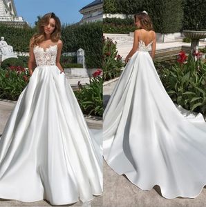 Top de malha transparente cetim linha A vestidos de noiva tule renda apliques corte trem sem costas jardim vestidos de noiva com bolsos