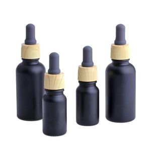 Frasco de perfume de óleo essencial de vidro preto fosco e líquido com conta-gotas de pipeta de reagente e tampa de grão de madeira 10/30ml Vsqlq