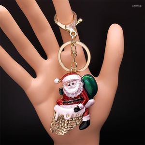 Schlüsselanhänger Netter Weihnachtsmann, der den Schornstein klettert, bringt Geschenk-Schlüsselanhänger, rote Farbe, Schlüsselanhänger, Kinderjahr, Weihnachtsfeier, bunter Schmuck